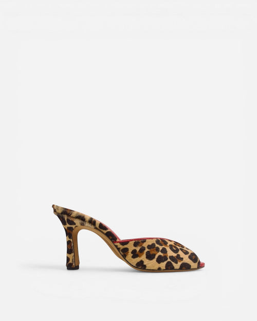 NOU leopard print ponyhair mule heels with a pointed toe and stiletto heel. Red interior.
