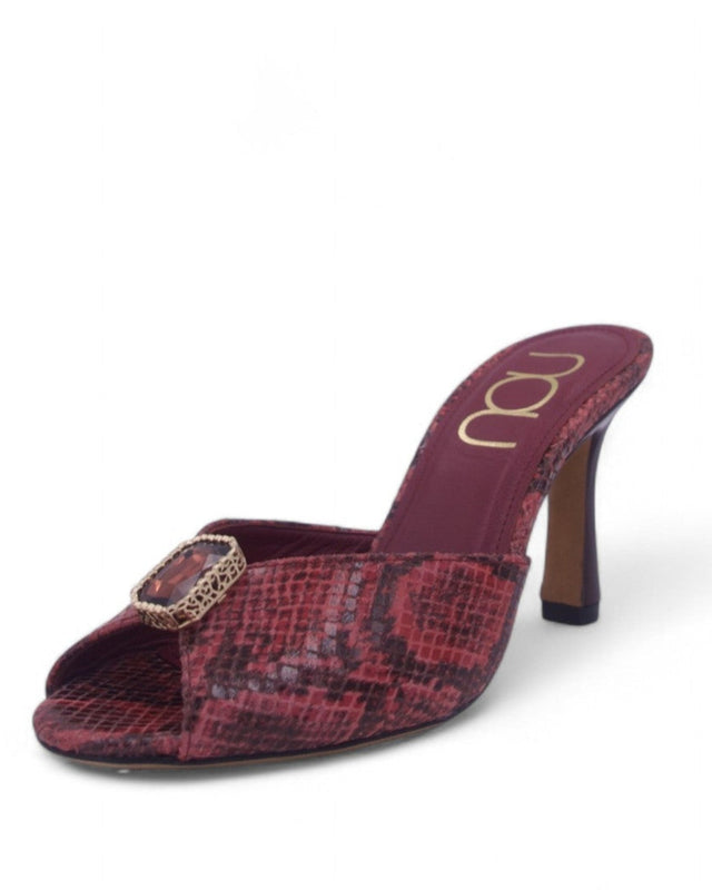 Red snake print mule high heel with a ruby gem on a white background