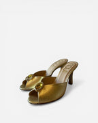 NOU gold metallic leather mules with open toe and jeweled embellishment on a stiletto heel.
