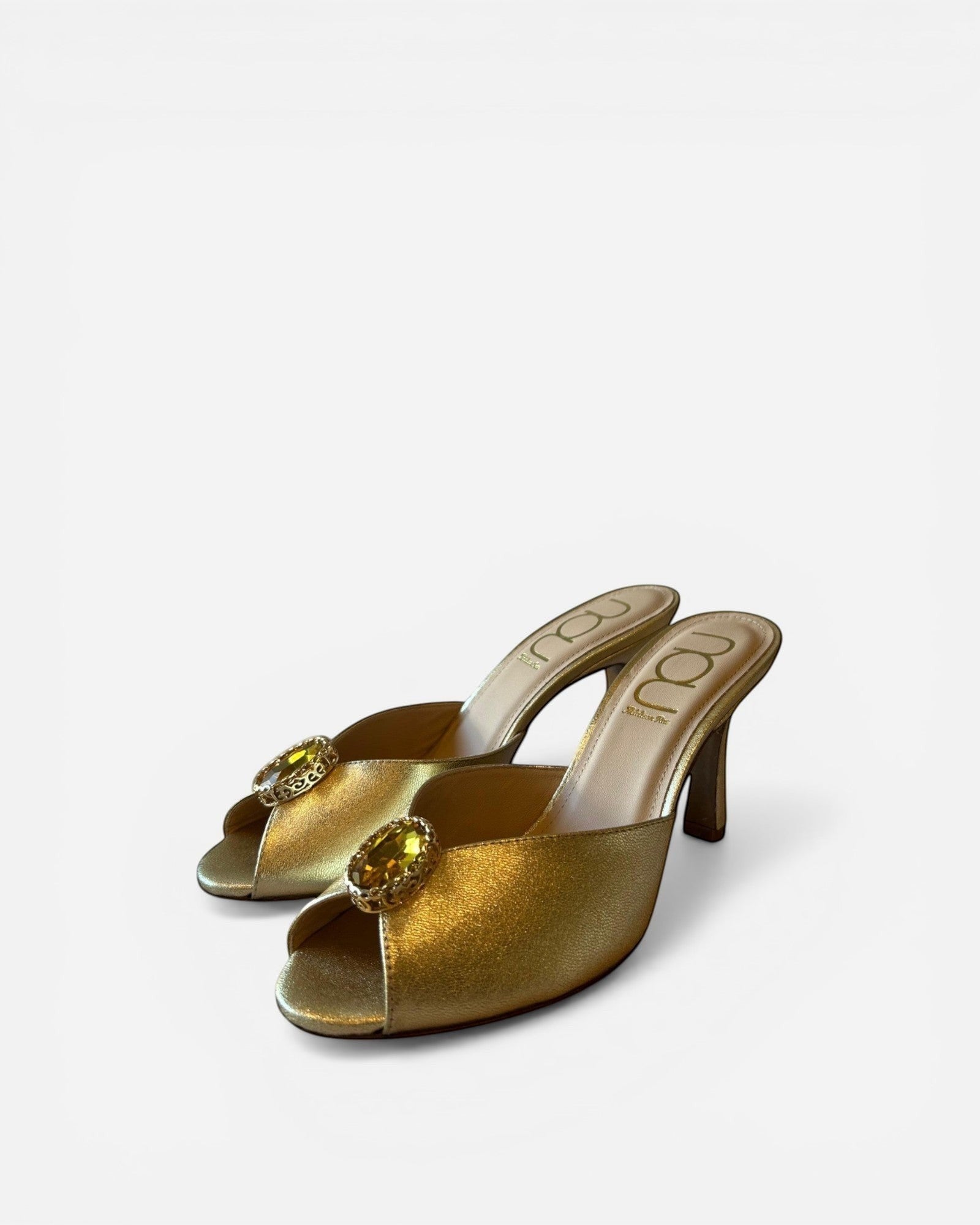 NOU gold metallic leather mules with open toe and jeweled embellishment on a stiletto heel.