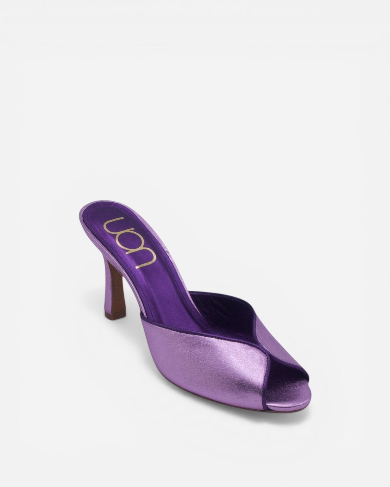 Purple high-heeled shoe on a white background