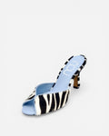 Zebra print sandal with a blue sole on a white background