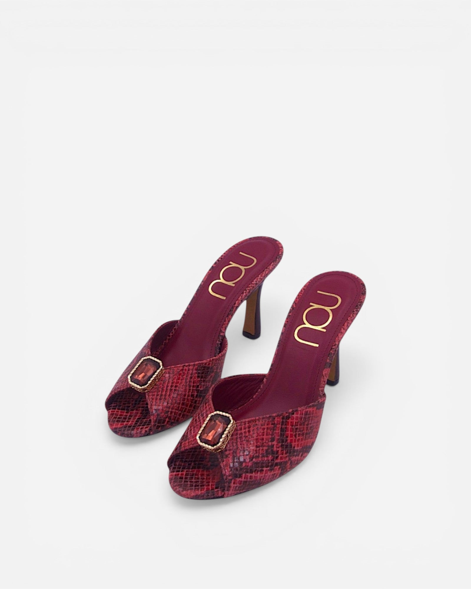 NOU red snakeskin leather mules with ruby gemstone accent and peep toe.
