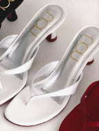 White sandals with 'nou' branding on a light background