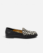 NOU The Driver loafer in black leather with a Dalmatian print ponyhair vamp and gold interior lining.