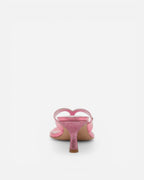 Pink high-heeled shoe with a heart design on a white background