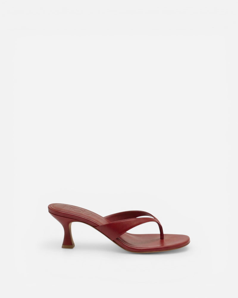 Red sandal with thin strap on a white background