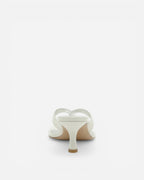 White sandal with a heart-shaped design on a white background