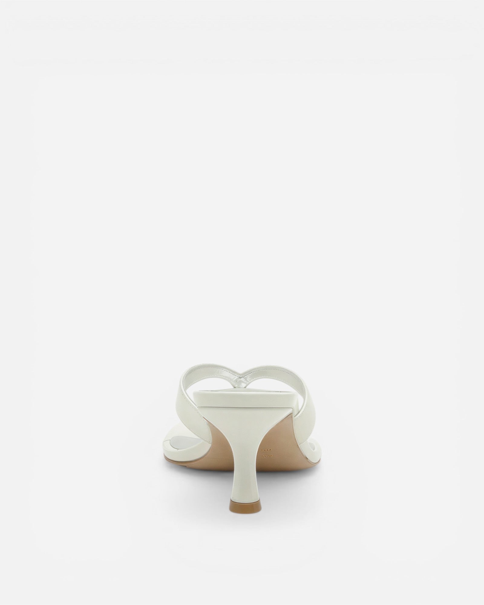 White sandal with a heart-shaped design on a white background