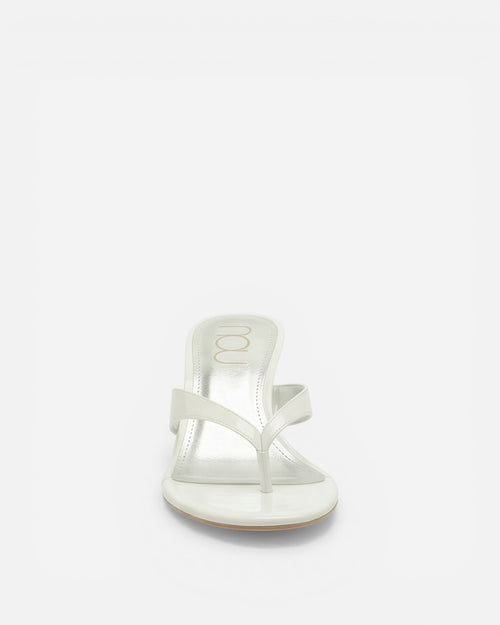 White sandal on a light beige background
