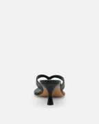 Black sandal with a thin heel on a white background
