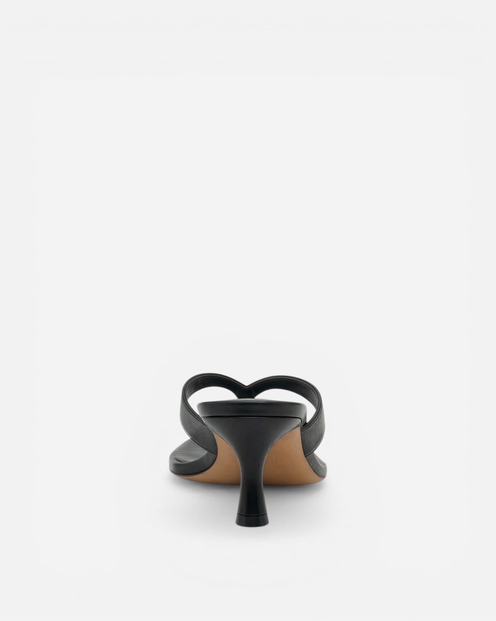 Black sandal with a thin heel on a white background
