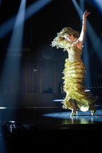 NOU The Addison Mule gold sequin fringe dress with matching heels on stage.