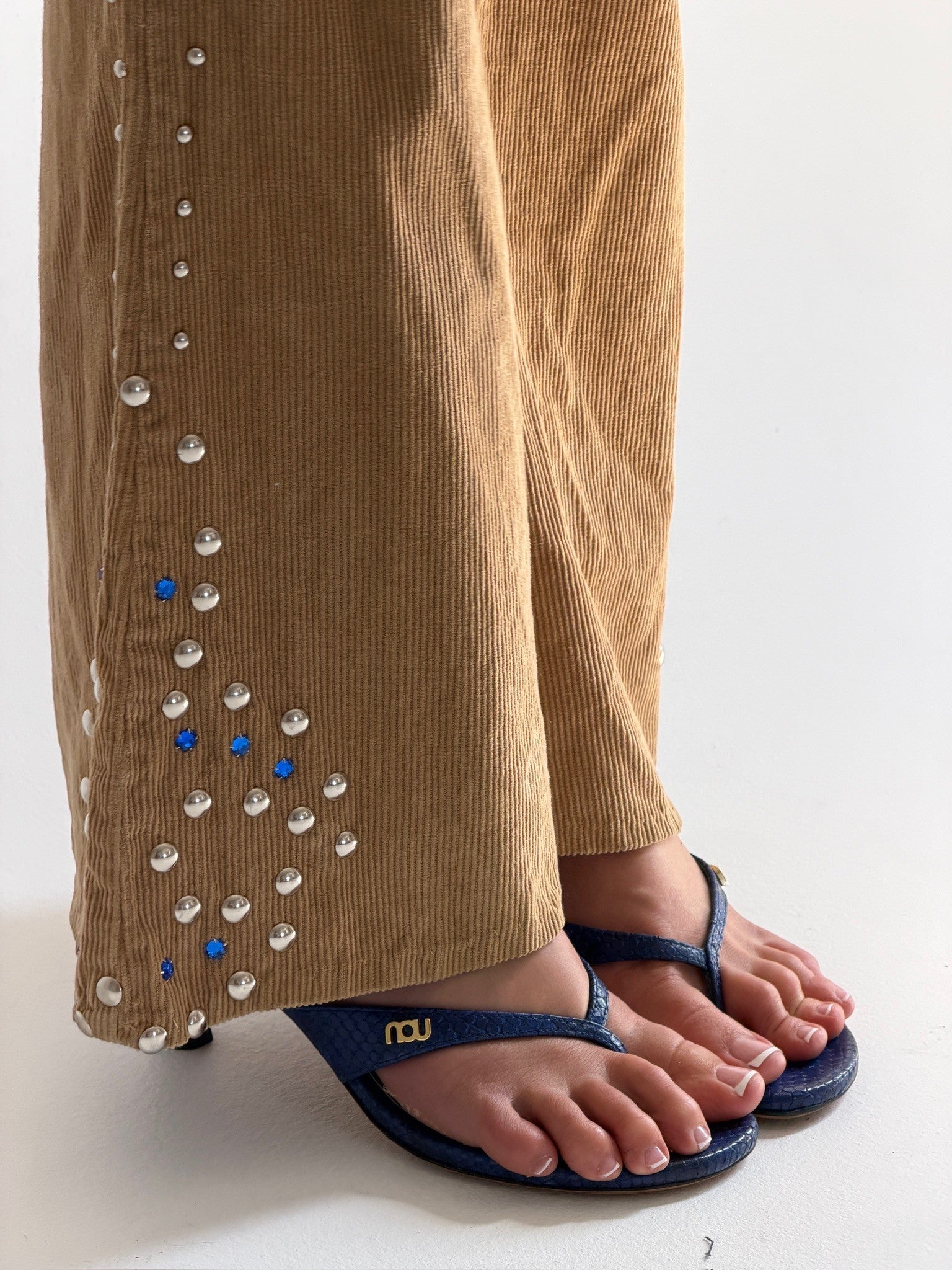 NOU The Kitty blue embossed snakeskin leather kitten heel sandals worn with tan corduroy pants featuring silver studs