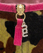 NOU The Boot featuring Undercover Lover camo ponyhair, metallic burgundy trim, and a rhinestone nou logo zipper pull.