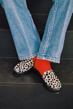 NOU The Driver black leather loafer with Dalmatian print ponyhair and gold interior lining in a red sock on model