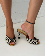 NOU The Mule in dalmatian print ponyhair with a metallic gold insole and open-toe kitten heel design.