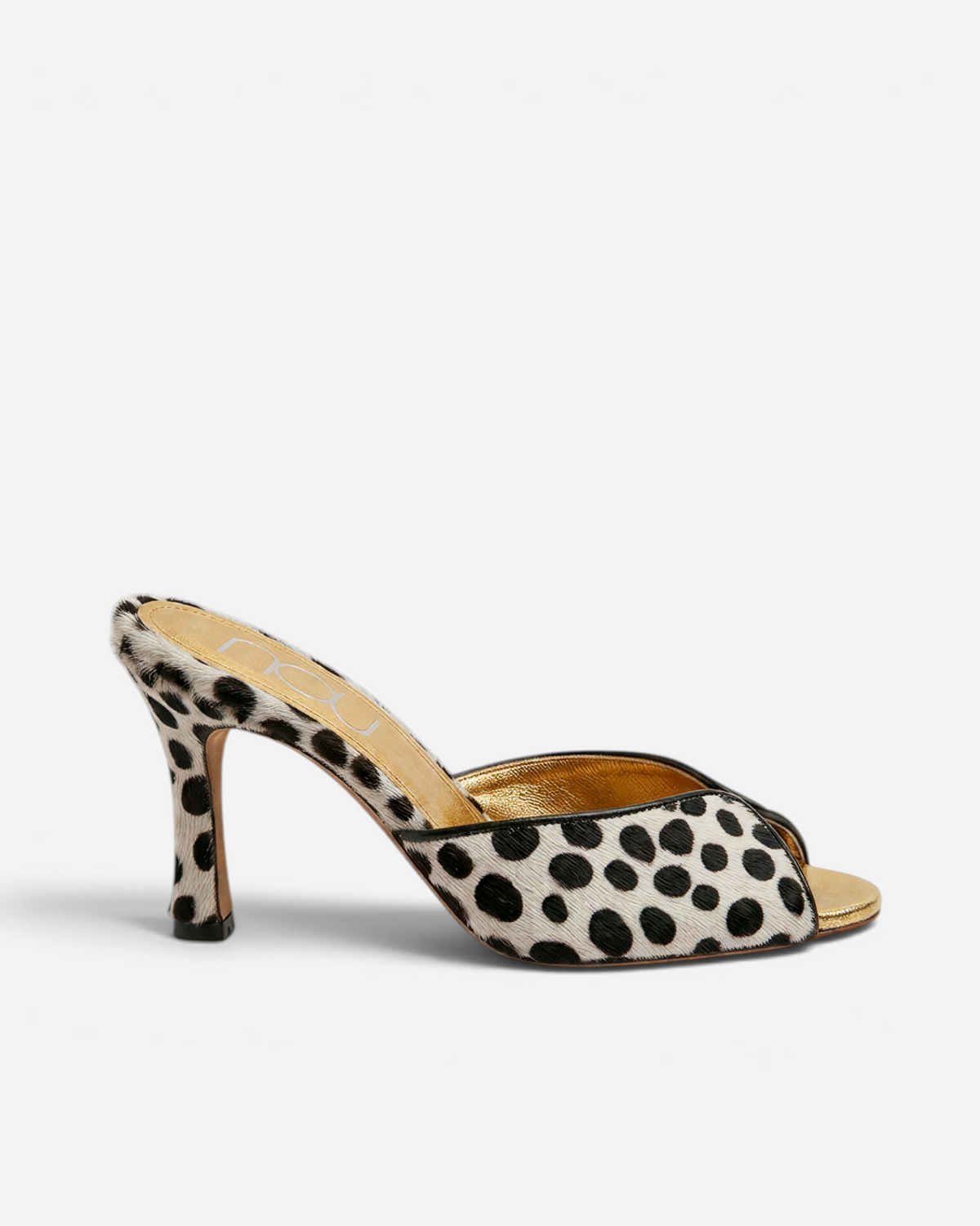 NOU The Mule in dalmatian print ponyhair with a metallic gold insole and stiletto heel, side profile view.