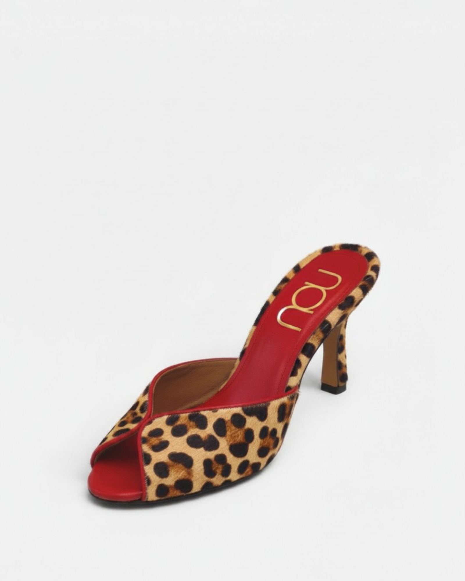 NOU The Mule in leopard print ponyhair with a vibrant red interior and stiletto heel.