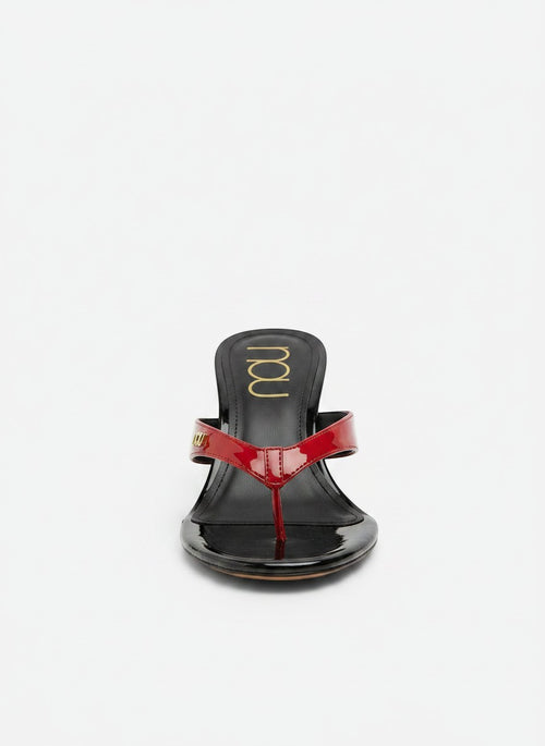 NOU The Puff Wedge patent flip-flop sandals in red and black with a 3" heel and gold logo detail.