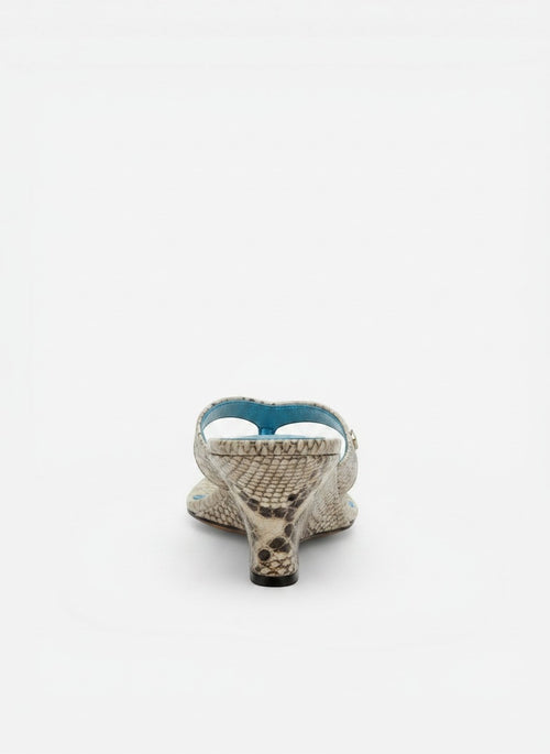 NOU The Puff Wedge sandals in icy silver snakeskin with a 3" sculptural wedge heel and plush straps. Blue insole.