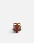 NOU The Puff Wedge in blood orange snakeskin with a 3-inch sculptural heel and gold logo detail, back view.