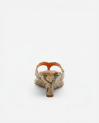 NOU The Puff Wedge in Creamsicle python snakeskin finish with a 3-inch sculptural heel and metallic orange insole.