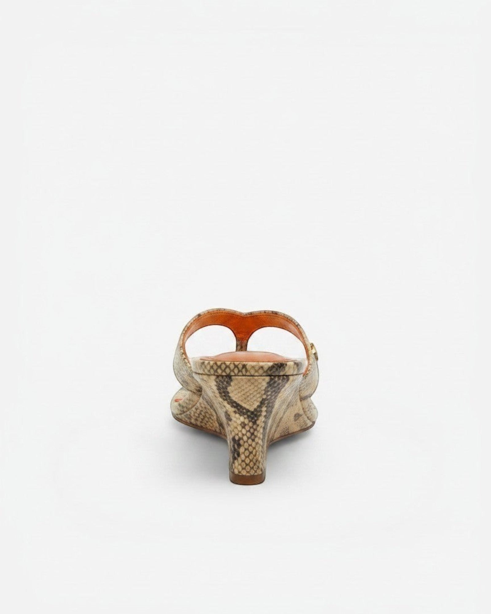 NOU The Puff Wedge in Creamsicle python snakeskin finish with a 3-inch sculptural heel and metallic orange insole.