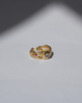 NOU Sirena adjustable toe ring in 24K gold-plated sterling silver with small gemstone accents on a white surface.