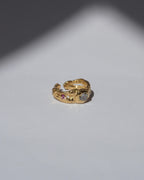 NOU Sirena adjustable toe ring in 24K gold-plated sterling silver with small gemstone accents on a white surface.