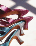 NOU The Kitty kitten heel sandals in bubblegum pink and metallic blue with glitter heels and contoured straps.
