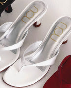 NOU The Kitty white coconut thong sandals with 1.5-inch sculpted kitten heels and padded insoles.