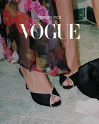 NOU The Mule black satin open-toe heels with cream leather trim and a 3-inch heel, worn by a model in a floral dress.