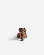 NOU The Mule in tiger print ponyhair with a metallic pink insole, shown from a rear angle.