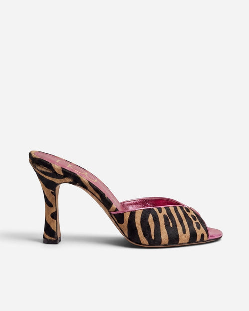 NOU The Mule in tiger-print ponyhair with a metallic pink insole and high heel, side view.
