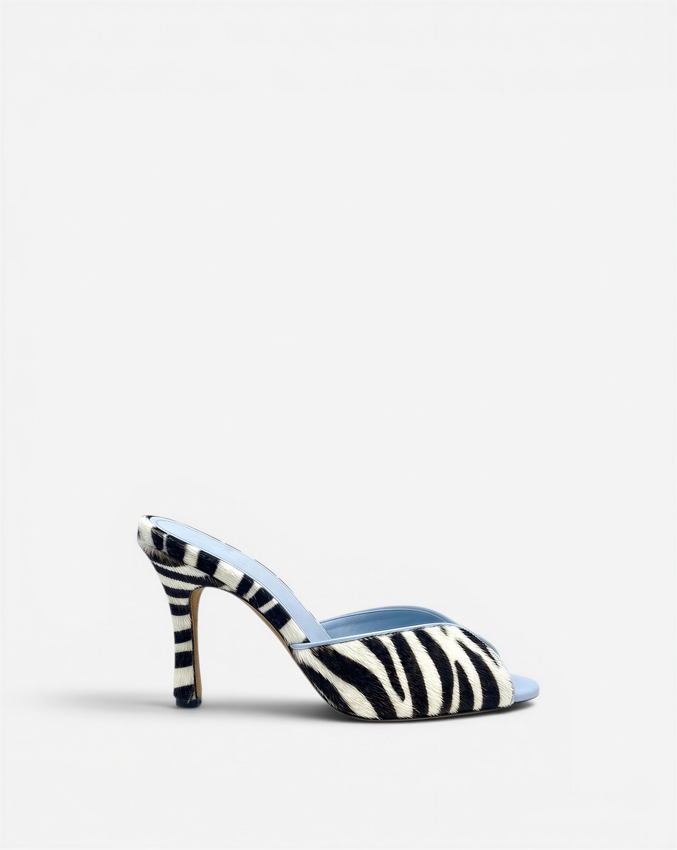 NOU black and white zebra print ponyhair mule with light blue lining and stiletto heel.