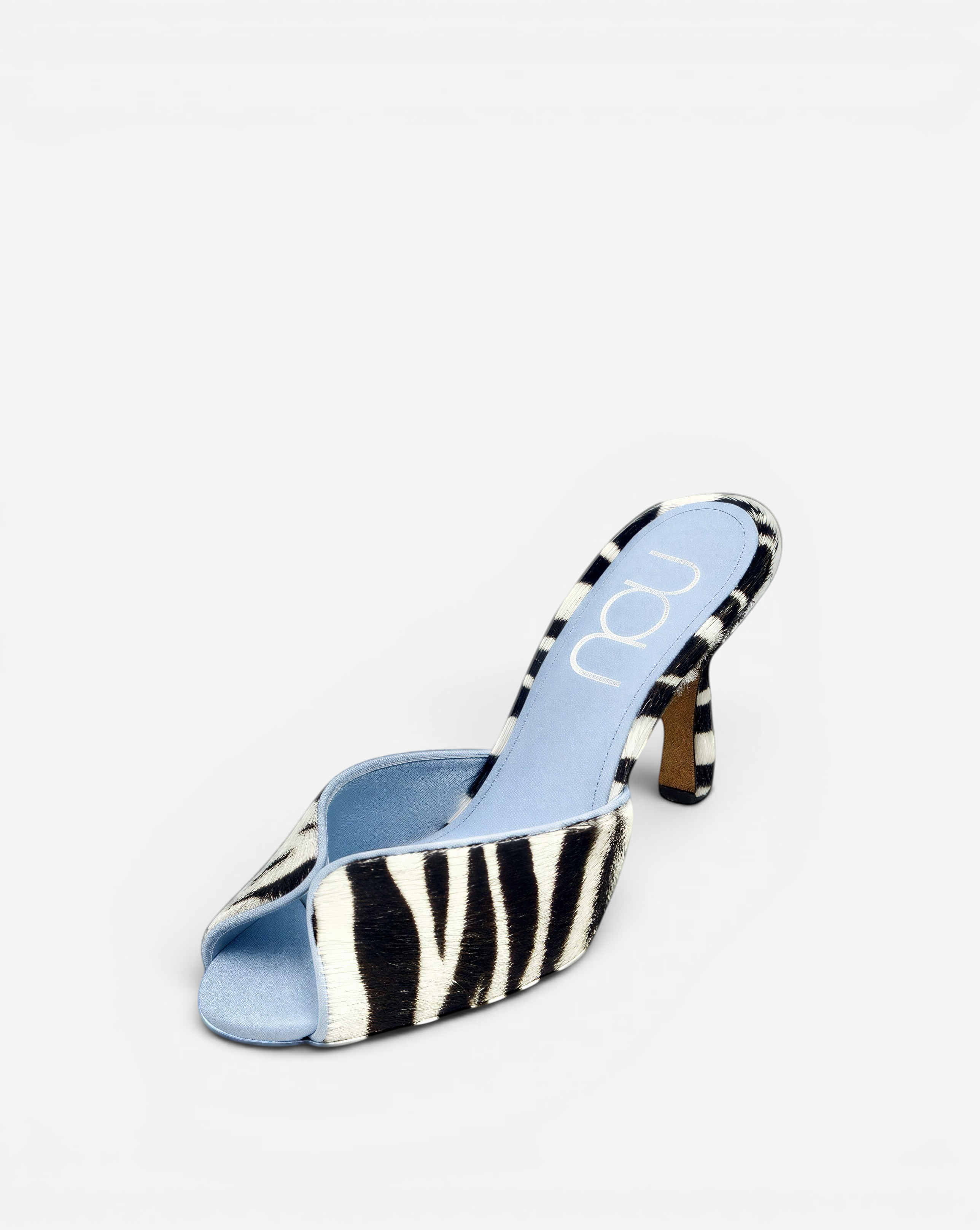 NOU The Mule slip-on heels in zebra-print Italian ponyhair with a light blue satin insole and stiletto heel.