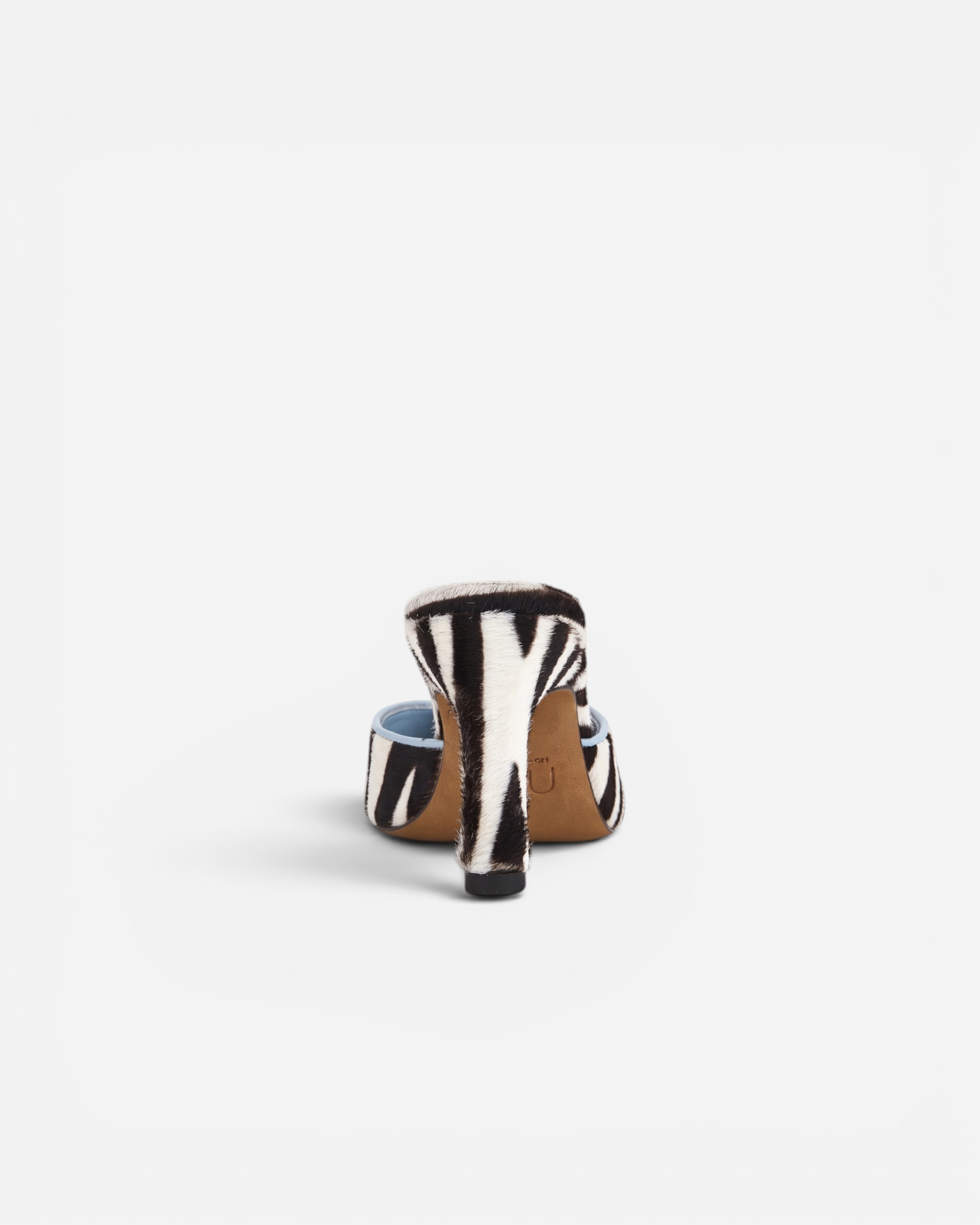 NOU The Mule slip-on shoe in black and white zebra print Italian ponyhair with a light blue interior lining