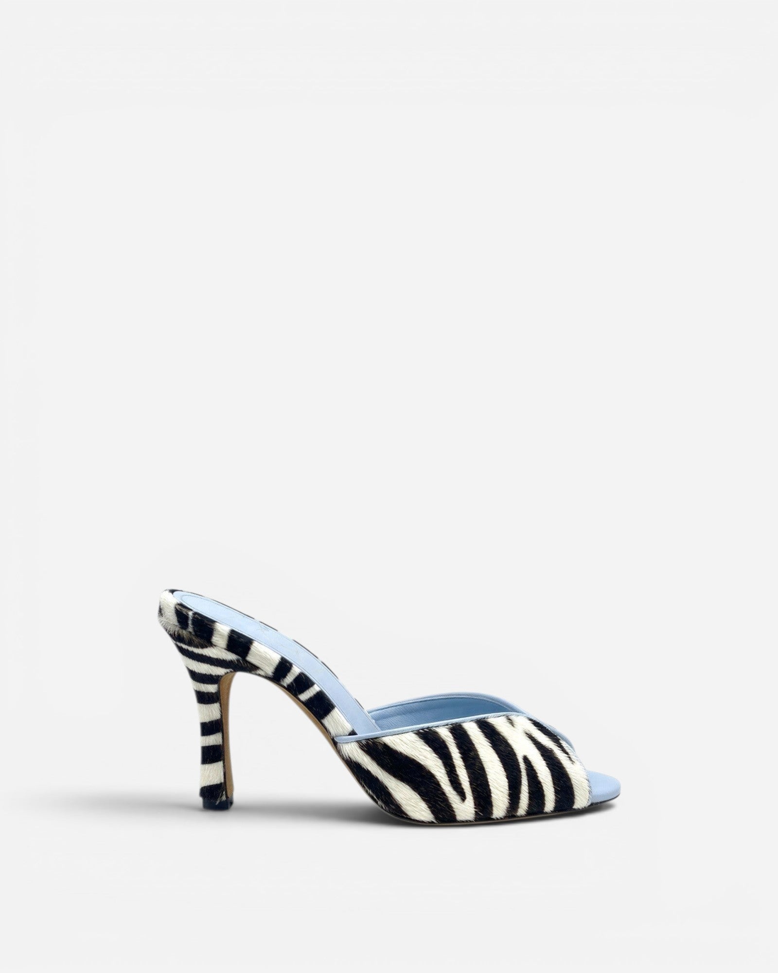 NOU black and white zebra print ponyhair mule with light blue lining and stiletto heel.